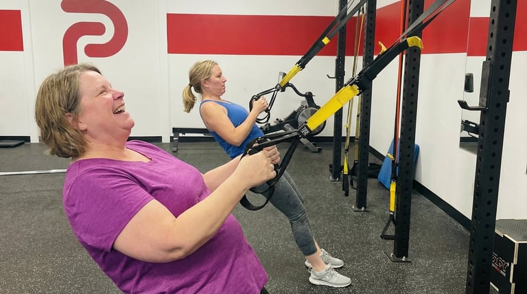 Woman training with TRX straps at Evolve Kickbox & Fitness